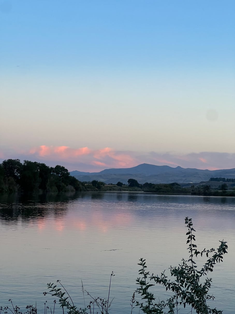 Pink sunset reflected on the Snake River with the Owyhee Mountains on the horizon, Marsing, Idaho